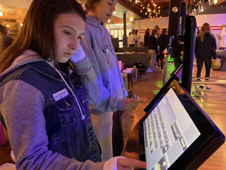 Sophomore Carley Dumaresq typing her name into the STRYXE Bowling computer system on March 1st, 2022.