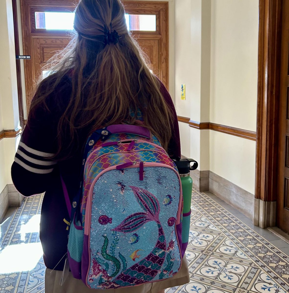 Abigail Villa 24 showing off her mermaid sequin backpack.